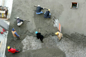 construction workers spreading concrete