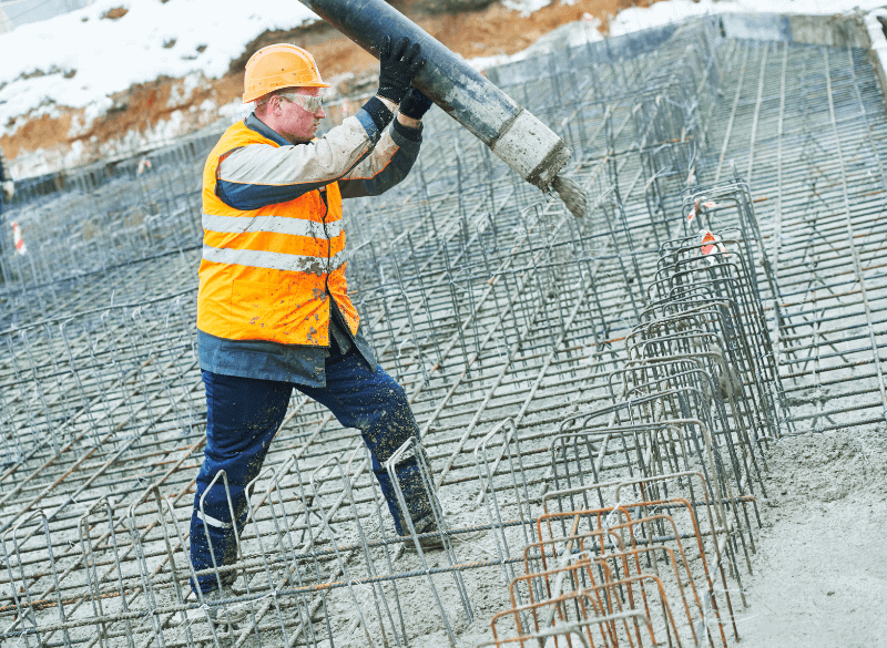 Construction worker pouring concrete